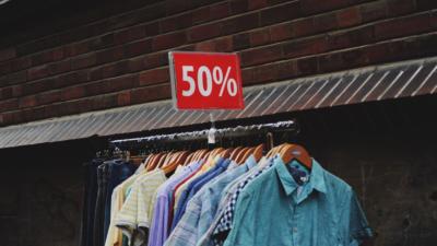 vintage clothing rack marked 50 percent off